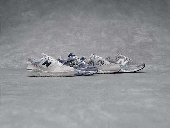 Side view of four grey New Balance sneakers.